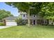 Charming two-story home featuring a brick and siding facade, attached two-car garage and beautiful landscaping at 11409 Haverstick Rd, Carmel, IN 46033