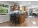 Bright kitchen with stainless steel appliances, a breakfast bar, and an adjacent dining area at 11409 Haverstick Rd, Carmel, IN 46033