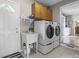 Laundry room with washer, dryer, sink, cabinets, and convenient access to the outside at 11409 Haverstick Rd, Carmel, IN 46033