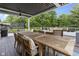 Outdoor patio with large wooden table and chairs perfect for entertaining guests at 11409 Haverstick Rd, Carmel, IN 46033