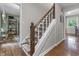 Staircase with wooden banister and carpeted steps connecting the main level to the upper floor at 11409 Haverstick Rd, Carmel, IN 46033