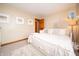 Bright bedroom with plush white bedding, complementary artwork, and neutral carpet at 1145 Forest Commons Dr, Avon, IN 46123