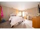 Bedroom with pink and white bedding, adjacent windows, and wooden furniture at 1145 Forest Commons Dr, Avon, IN 46123