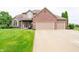 Inviting two-story home featuring a brick facade, attached two-car garage, and well-manicured front lawn at 1145 Forest Commons Dr, Avon, IN 46123