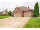Beautiful home showcasing a three-car garage, brick exterior, and a well-maintained driveway at 1145 Forest Commons Dr, Avon, IN 46123