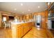 Open kitchen with stainless steel appliances and a center island adjacent to the dining area at 1145 Forest Commons Dr, Avon, IN 46123