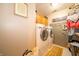 Functional laundry room with modern washer, dryer, upper cabinets, and rustic sliding door at 1145 Forest Commons Dr, Avon, IN 46123