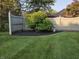 Landscaped backyard featuring well-maintained lawn, tasteful plantings, and privacy fencing at 1201 Briarwood Dr, Brownsburg, IN 46112