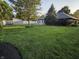Large backyard with mature trees, pristine lawn, and a patio area for outdoor enjoyment at 1201 Briarwood Dr, Brownsburg, IN 46112