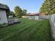 Spacious backyard with a storage shed, lush lawn, and manicured landscaping at 1201 Briarwood Dr, Brownsburg, IN 46112