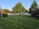 Grassy backyard, mature trees, and fenced perimeter offer privacy and space at 1201 Briarwood Dr, Brownsburg, IN 46112