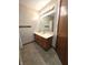 Bathroom featuring a wooden vanity and well-lit mirror above a tiled floor at 1201 Briarwood Dr, Brownsburg, IN 46112