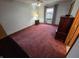 Comfortable bedroom with neutral carpeting, a bright window, and classic wood furniture at 1201 Briarwood Dr, Brownsburg, IN 46112