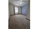 Spacious bedroom with blue accent wall, neutral carpeting, and ample natural light at 1201 Briarwood Dr, Brownsburg, IN 46112