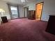 Spacious bedroom with plush carpeting, dresser, a window, and a view into the bathroom at 1201 Briarwood Dr, Brownsburg, IN 46112