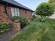 Landscaped side yard featuring mature landscaping and a well-maintained lawn at 1201 Briarwood Dr, Brownsburg, IN 46112