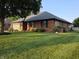 Charming brick home featuring an attached garage, mature trees, and a well-maintained lawn at 1201 Briarwood Dr, Brownsburg, IN 46112