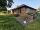 Beautiful brick house featuring manicured landscaping, flowering plants, and a well-maintained lawn at 1201 Briarwood Dr, Brownsburg, IN 46112