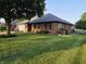 Charming brick home featuring an attached garage, mature trees, and a well-maintained lawn at 1201 Briarwood Dr, Brownsburg, IN 46112