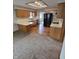 Efficient kitchen featuring oak cabinets, modern black appliances, and wood-look flooring at 1201 Briarwood Dr, Brownsburg, IN 46112