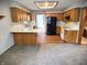Well-lit kitchen featuring oak cabinets, modern white appliances, and black refrigerator at 1201 Briarwood Dr, Brownsburg, IN 46112