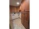 Functional laundry area with lots of wooden cabinet space and neutral flooring at 1201 Briarwood Dr, Brownsburg, IN 46112