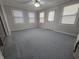 A living room that features new carpet, modern ceiling fan, and neutral gray walls at 1201 Briarwood Dr, Brownsburg, IN 46112