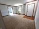 Inviting living room featuring neutral carpet, trim and a front door at 1201 Briarwood Dr, Brownsburg, IN 46112