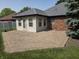 A brick patio is just outside the sun room on this home's back exterior at 1201 Briarwood Dr, Brownsburg, IN 46112