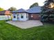 A brick patio is just outside the sun room on this home's back exterior at 1201 Briarwood Dr, Brownsburg, IN 46112