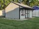 Well-maintained storage shed with a painted exterior, shingled roof, and surrounding landscaping at 1201 Briarwood Dr, Brownsburg, IN 46112