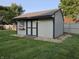 Well-maintained storage shed with a painted exterior, shingled roof, and surrounding landscaping at 1201 Briarwood Dr, Brownsburg, IN 46112