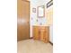 Compact bathroom with wood vanity, corner sink, and patterned tile flooring at 12014 Briar Way Center Dr, Indianapolis, IN 46126