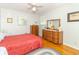 Bedroom featuring hardwood floors, two dressers, and ample natural light at 12014 Briar Way Center Dr, Indianapolis, IN 46126