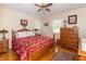 Cozy bedroom with hardwood floors, ceiling fan, and bright natural light from two windows at 12014 Briar Way Center Dr, Indianapolis, IN 46126