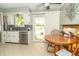Well-lit kitchen features white cabinets, stainless steel appliances, and an adjacent breakfast nook overlooking the backyard at 12014 Briar Way Center Dr, Indianapolis, IN 46126