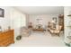 Bright living room with neutral walls, carpet, and traditional furniture shows inviting and comfortable space at 12014 Briar Way Center Dr, Indianapolis, IN 46126
