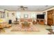 Spacious living room with large windows, a plush patterned sofa, and a decorative fireplace at 12014 Briar Way Center Dr, Indianapolis, IN 46126