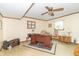 Cozy home office featuring wood paneling, ceiling fan and traditional-style desk with ornate rug at 12014 Briar Way Center Dr, Indianapolis, IN 46126