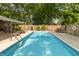 Backyard view of the in-ground pool with crystal-clear water and manicured landscaping provides a great place for relaxation at 12014 Briar Way Center Dr, Indianapolis, IN 46126