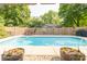 Backyard pool surrounded by a well-kept fence and lush greenery creates a private outdoor oasis at 12014 Briar Way Center Dr, Indianapolis, IN 46126