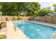 Sparkling in-ground swimming pool surrounded by decorative landscaping and a wooden fence at 12014 Briar Way Center Dr, Indianapolis, IN 46126