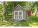 Wooden storage shed with double doors in a lush, green backyard setting at 12014 Briar Way Center Dr, Indianapolis, IN 46126