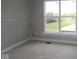 Unfinished bedroom with a large window overlooking a picturesque backyard with pond at 12338 French Cattle Way, Noblesville, IN 46060