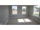 Unfinished bedroom featuring natural light and large windows with unfinished flooring at 12338 French Cattle Way, Noblesville, IN 46060