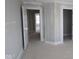 Spacious bedroom featuring neutral walls, two doors, and a sunlit window, creating a bright, unfinished space at 12338 French Cattle Way, Noblesville, IN 46060