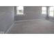 Unfinished bedroom bathed in natural light from two windows, showing base trim at 12338 French Cattle Way, Noblesville, IN 46060