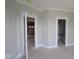 Unfinished hallway featuring doorways to various rooms and an entrance to a bathroom at 12338 French Cattle Way, Noblesville, IN 46060