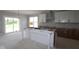 Future kitchen featuring white cabinets, an island, and sliding glass door to backyard at 12338 French Cattle Way, Noblesville, IN 46060