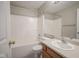 Well-lit bathroom featuring a shower-tub combo and vanity with modern fixtures at 12382 Cool Winds Way, Fishers, IN 46037